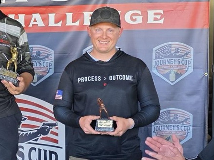 Darin Ellington holding his third-place trophy at the Journey's Cup Topshot Challenge