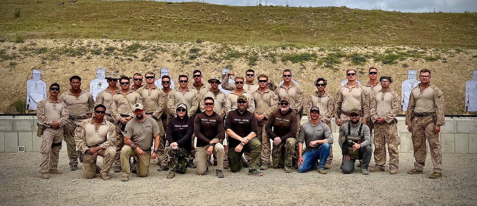 The Scoring Tech team with Marines on the range